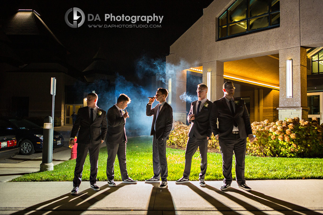 Creative portrait of Groomsman smoking cigars