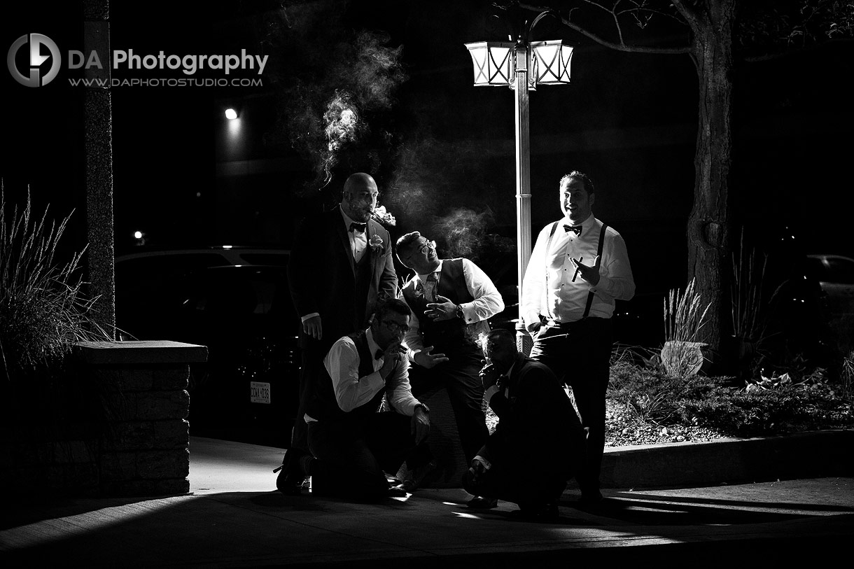 Nigh time Photography of a Groomsman's Smoking cigars at Bellagio Wedding