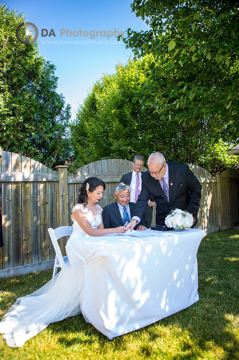 Bride and groom signing marriage certificate