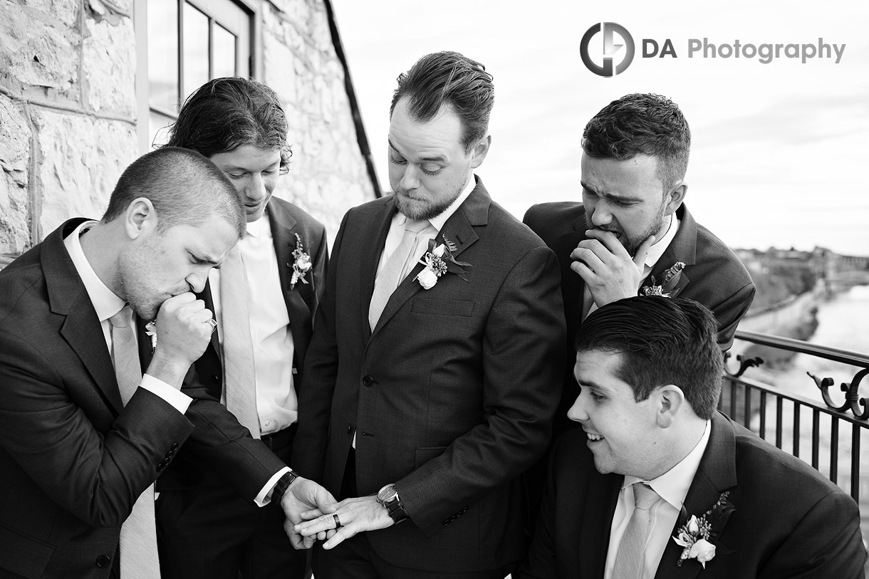 Fun photos of groomsman's at Cambridge Mill balcony