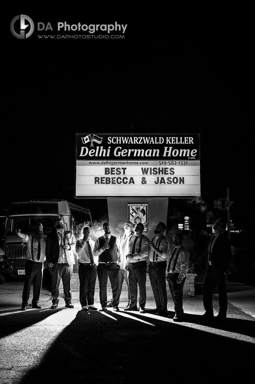 Creative photo of groomsman's at night smoking cigars