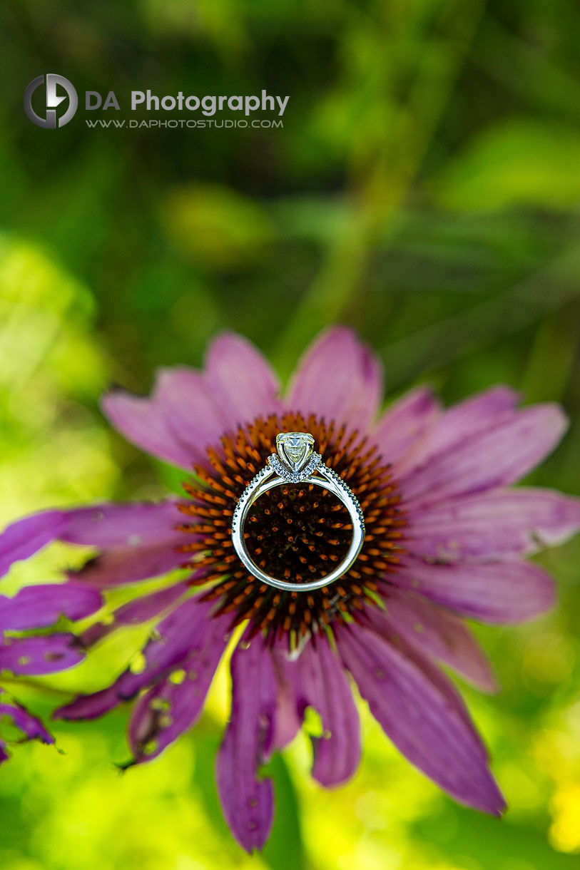 Close up photo of a Engagement ring on a flower