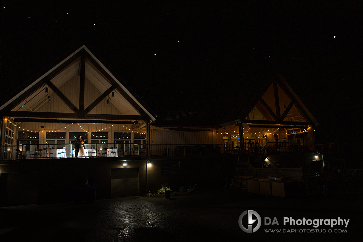 Photo of a Bride and Groom on a balcony at Tangle Creek during the night