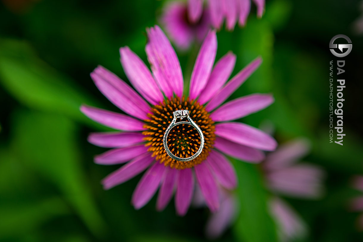 Close up photo of a engagement ring on top of a flower