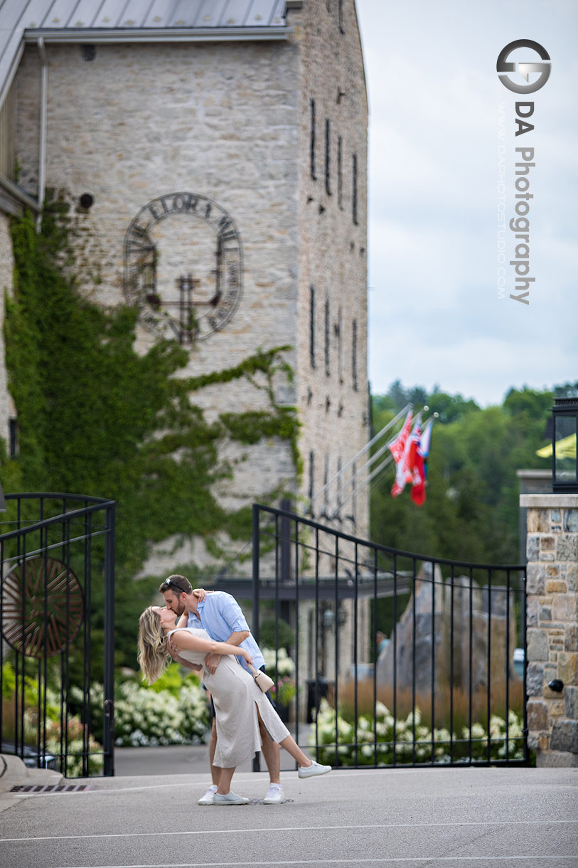 Creative engagement photos in front of Elora Mill Hotel and Spa