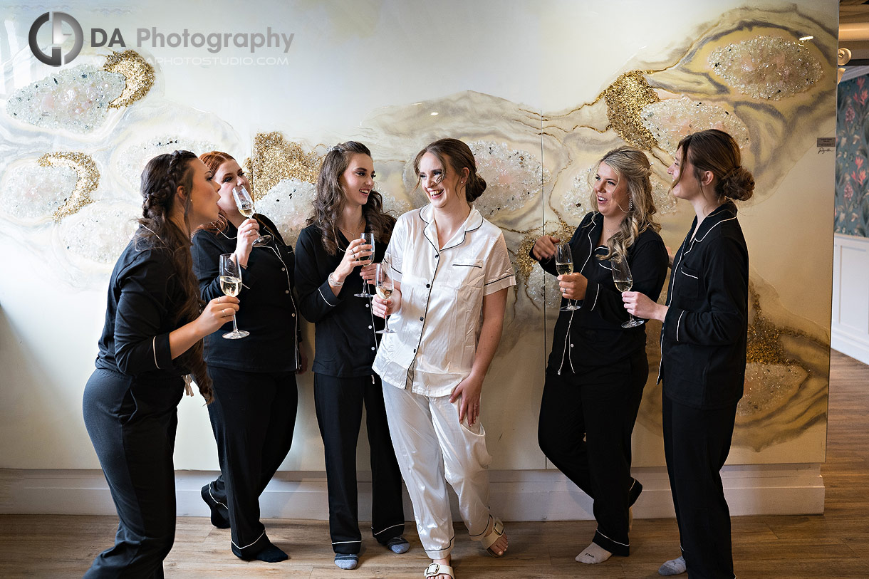 Bridesmaids having champagne by The Wall at Timber Barn