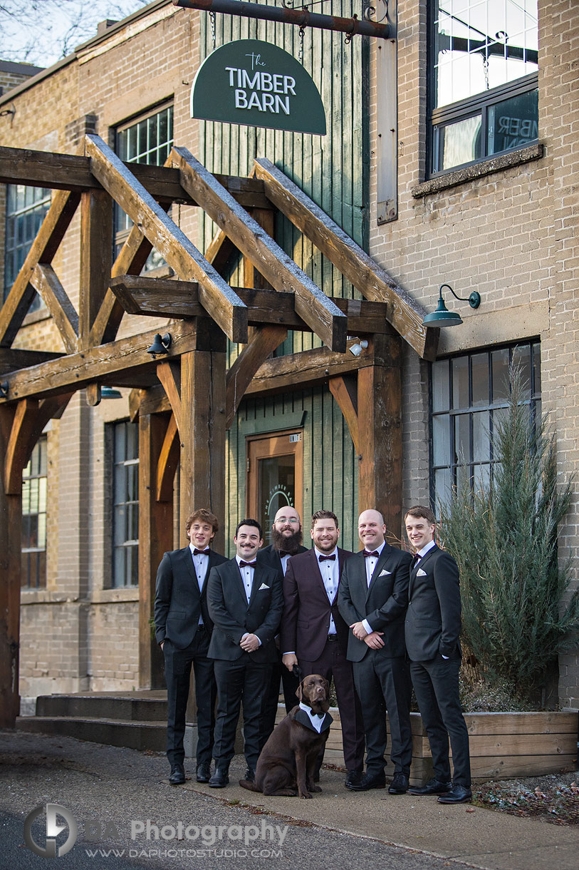 Photo of a Groom with his Groomsman in front of Timber Barn