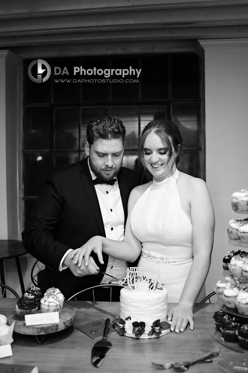 Bride and Groom cutting their wedding cake at Timber Barn
