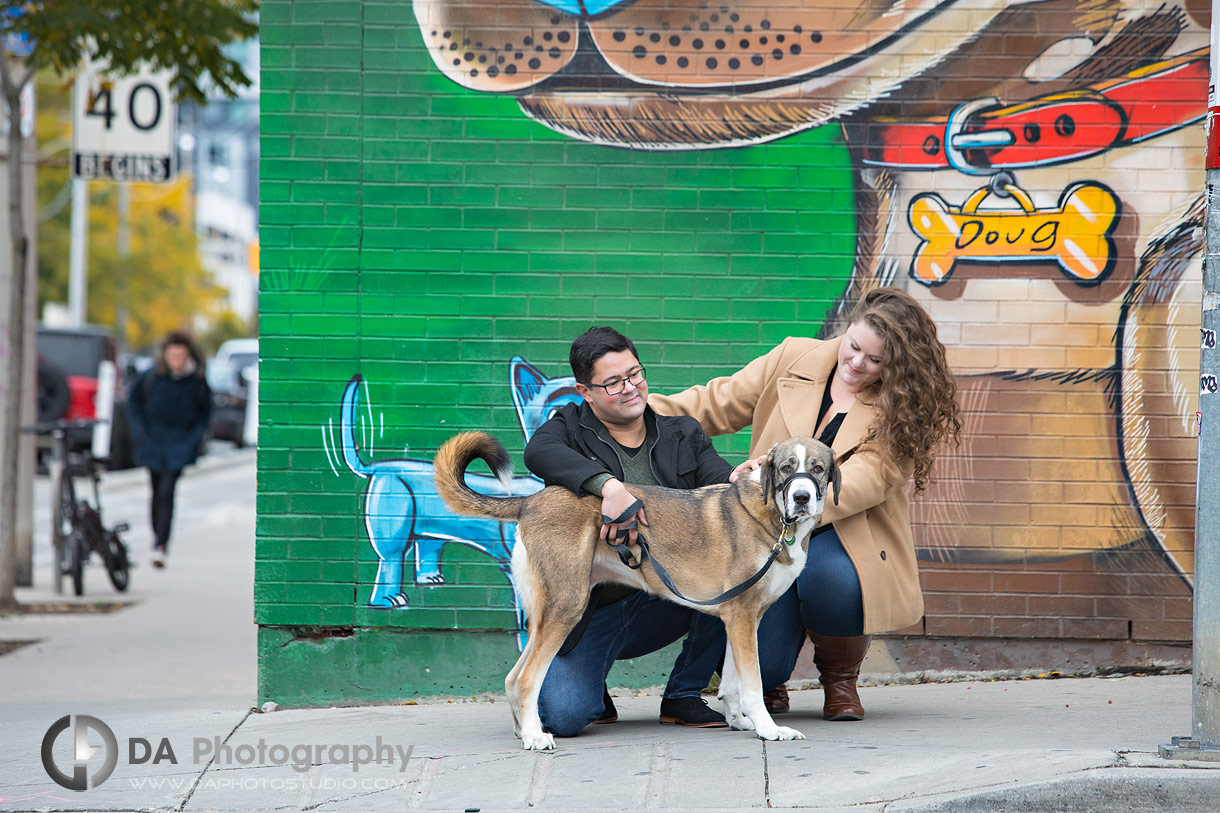 Engagement couple with their dog in front of Humane Society in Toronto