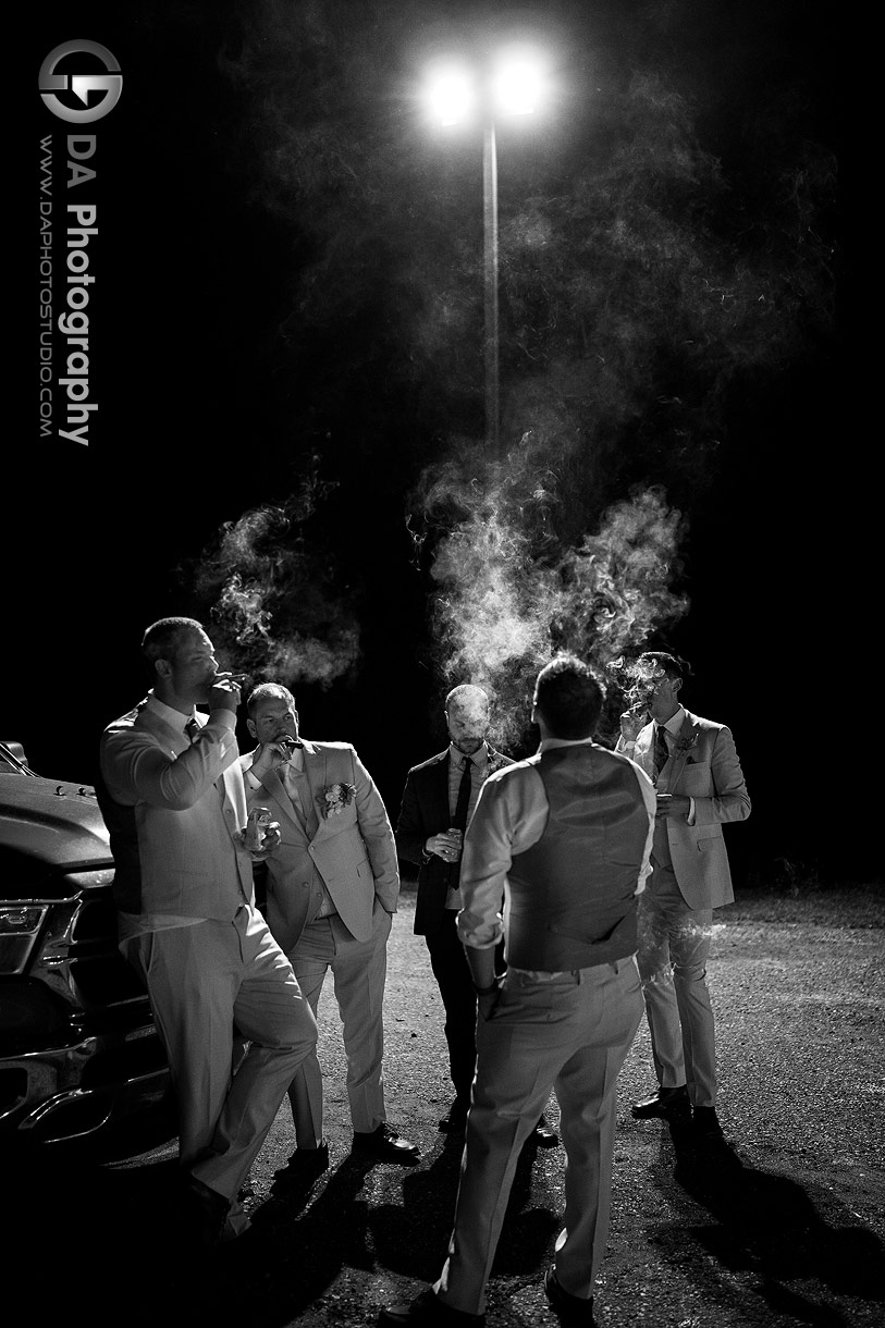 Photo of Groomsman's smoking cigars on a wedding day