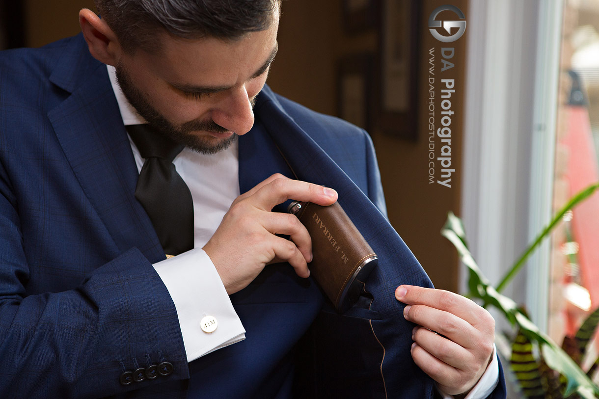 Photo of a groom securing his flask