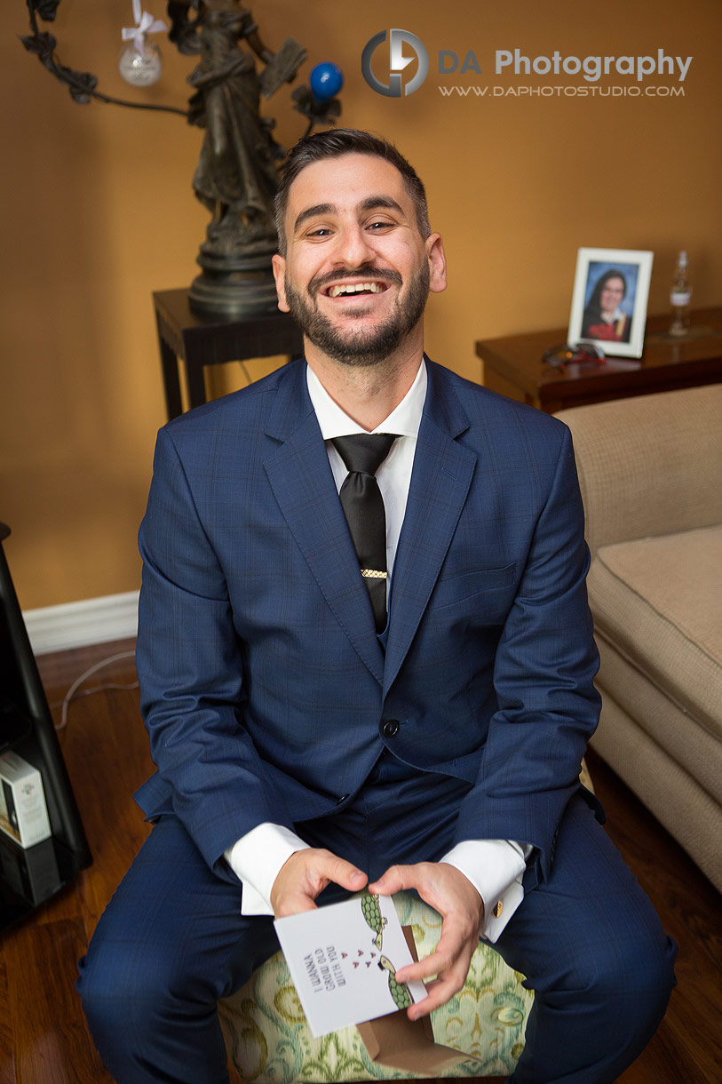 Groom reading a letter from his wife-to-be on a wedding day 