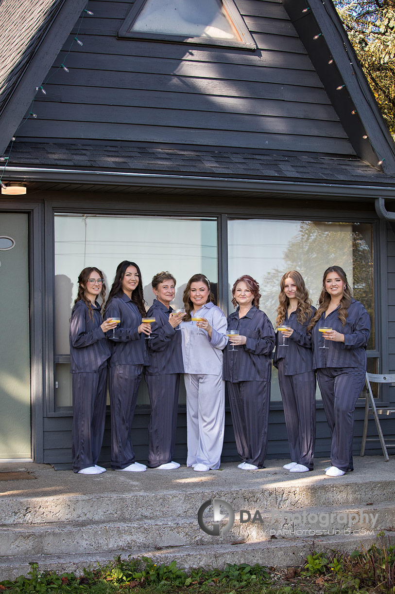 Photo of a bridesmaids in their PJ's drinking champagne 