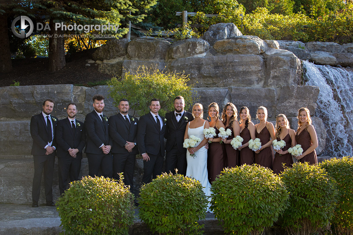 Photo of a bridal party by the waterfall at Whistle Bear