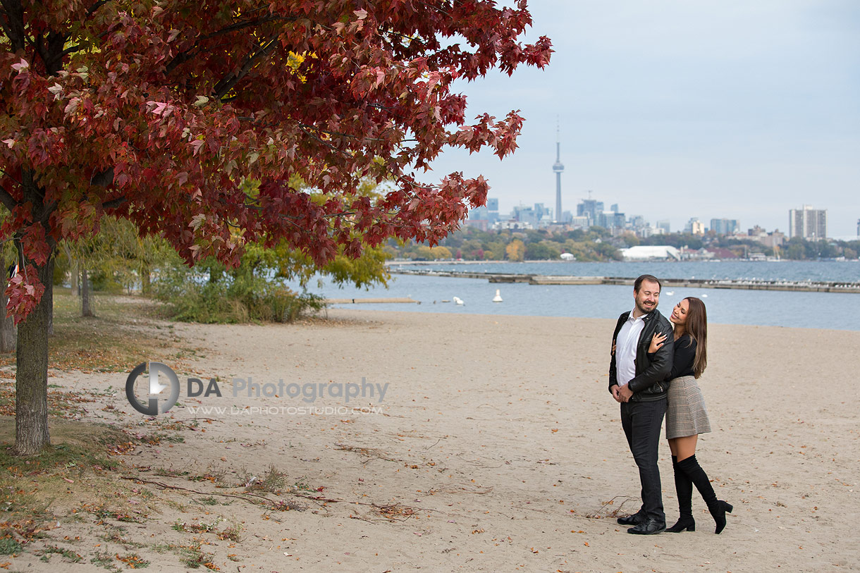 Intimate engagement at Toronto Beach with city skyline