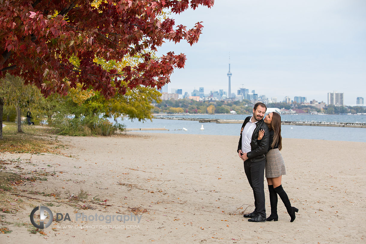 Engagement photography in Toronto on the beach with city skyline