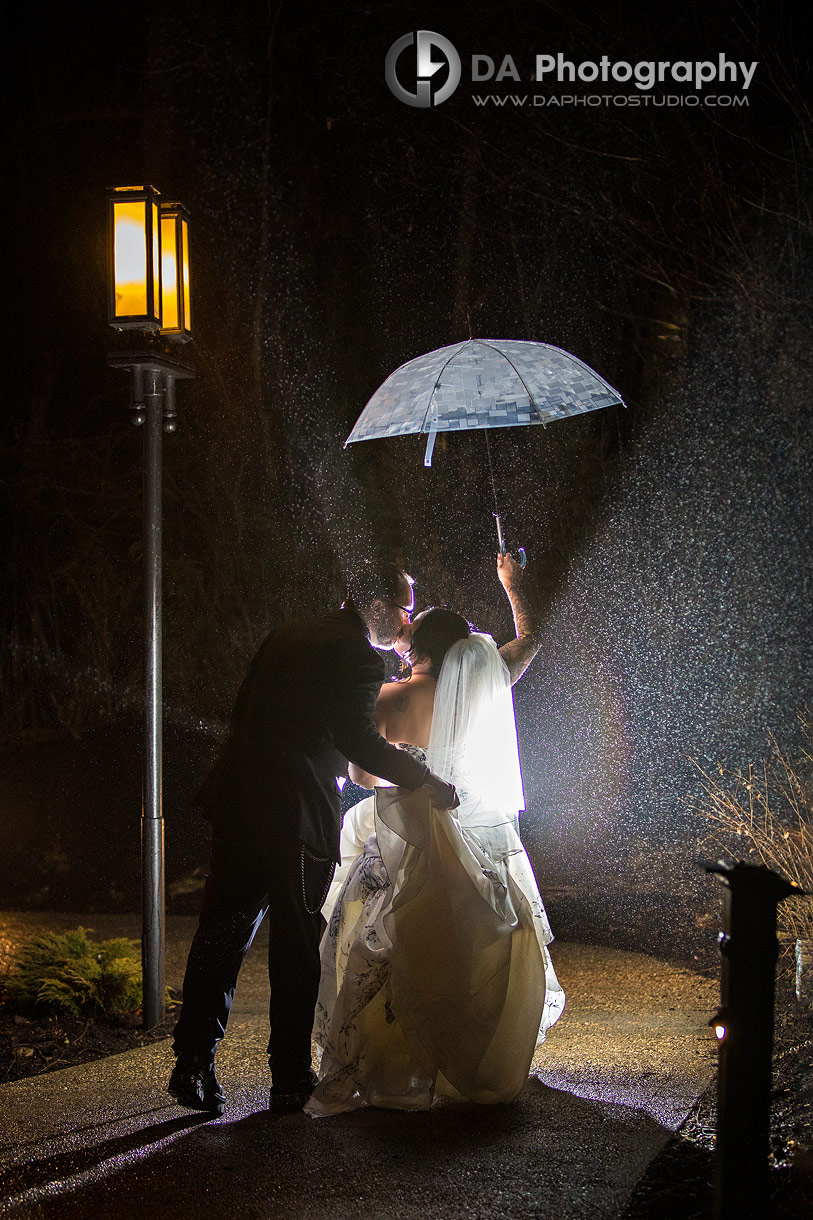 Photo of a Bride and Groom at Ancaster Mill at Night with umbrella