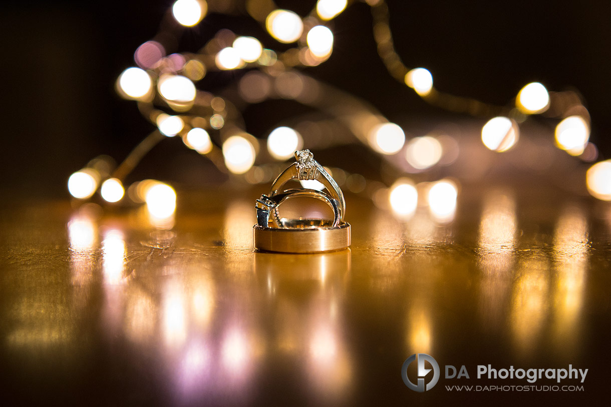 Close Up photo of a wedding rings with twinkling lights