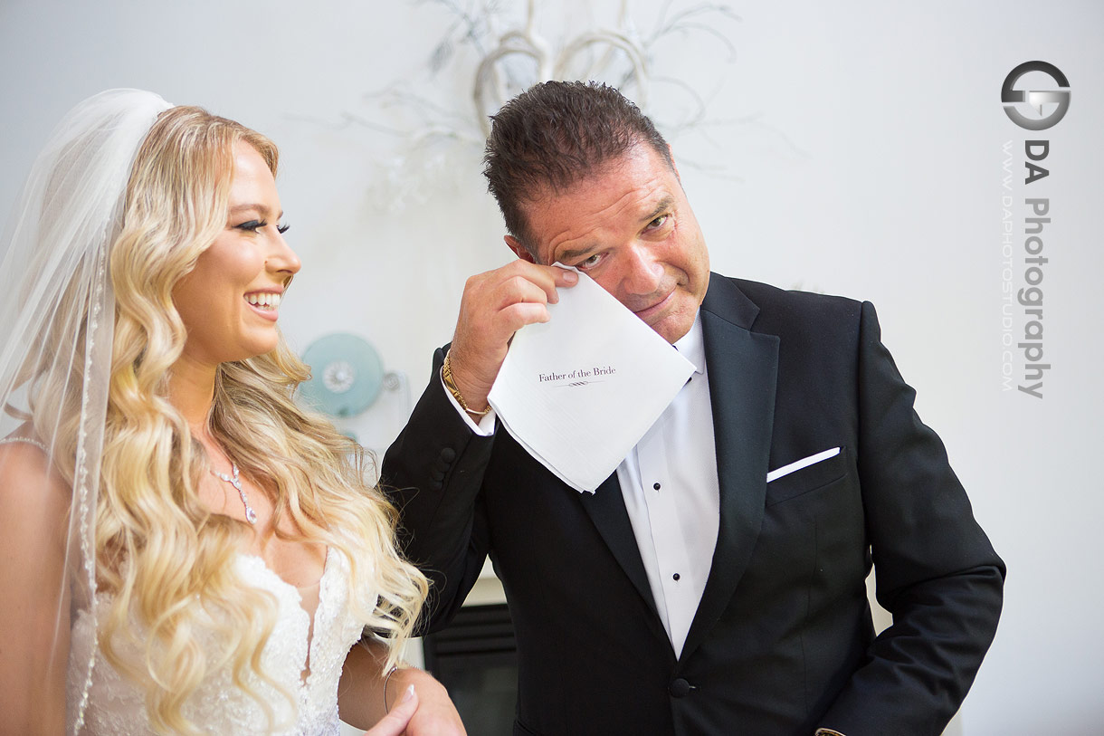 Dad wiping his tears after first look photo with his daughter on a wedding day morning