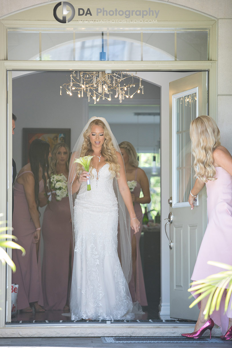 Bride exiting her home on a wedding day