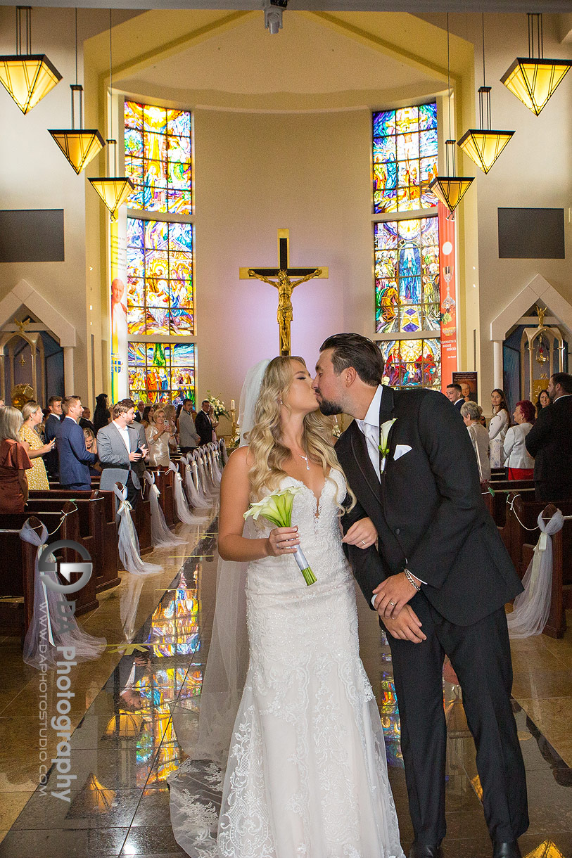 Bride and Groom kissing at St. Eugene de Mazenod Parish Church