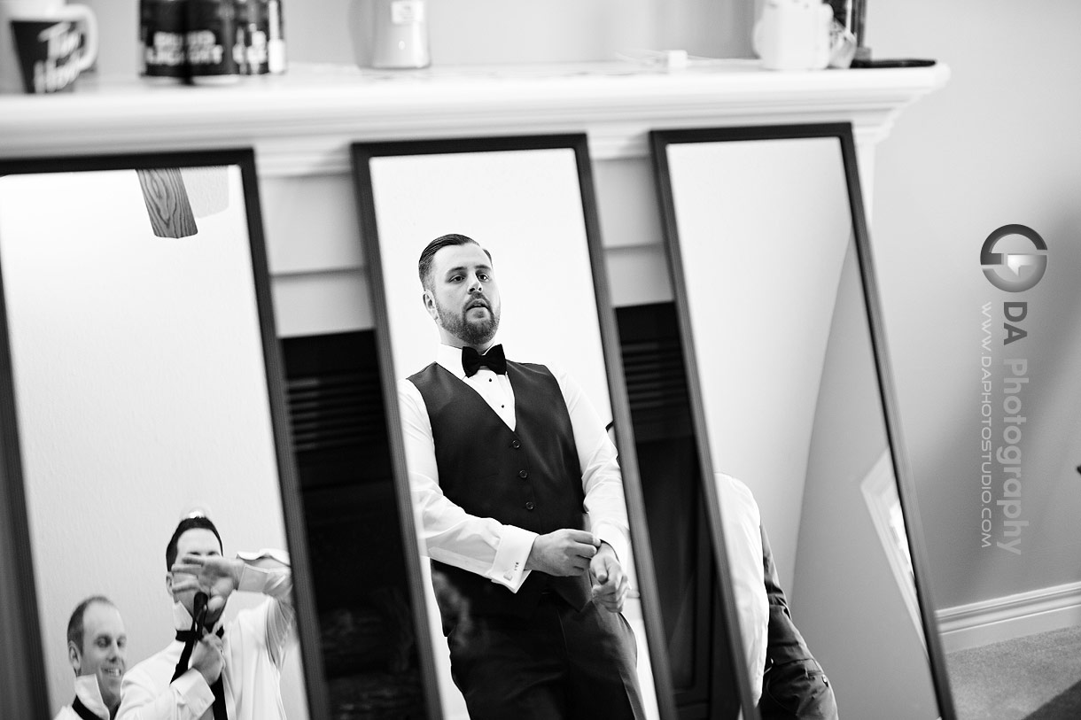 Photo of a Groom in front of a mirrors Photo of a Groom in front of a mirrors