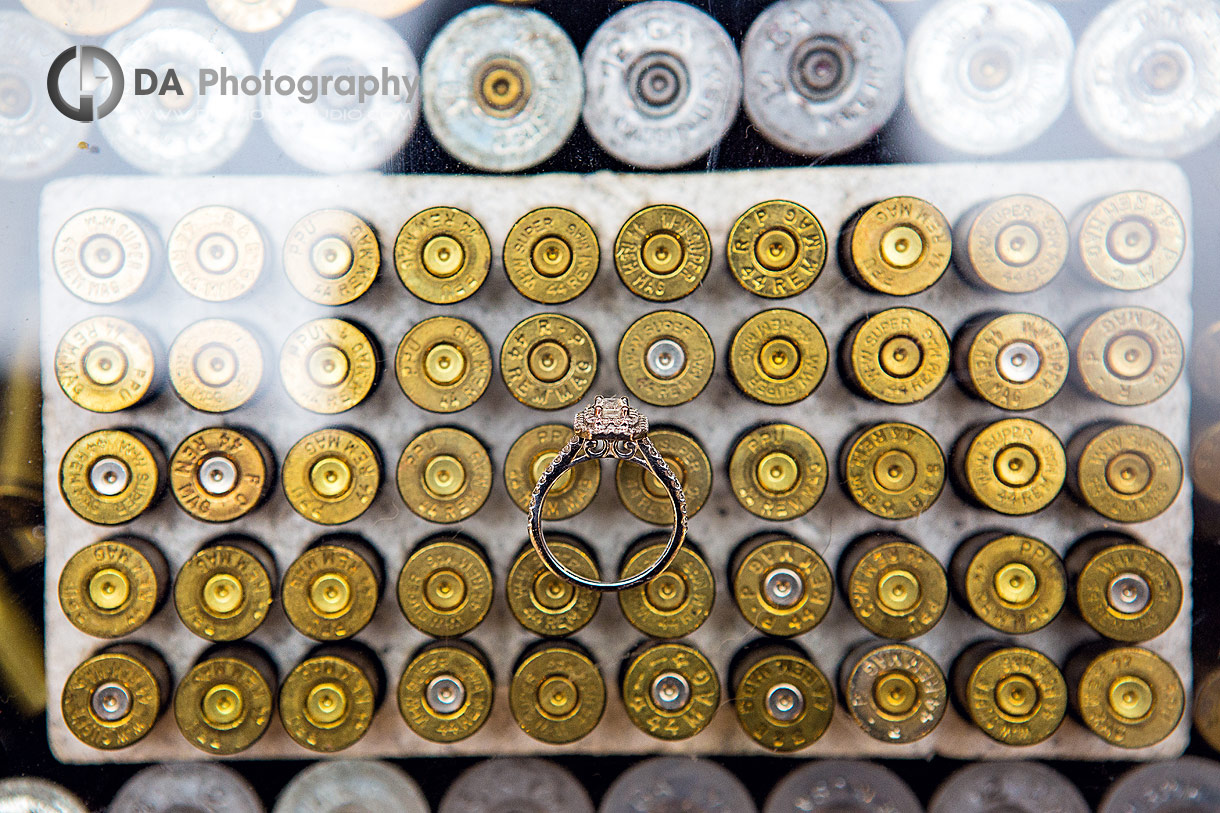 Close up photo of a wedding ring on a used bullet casings