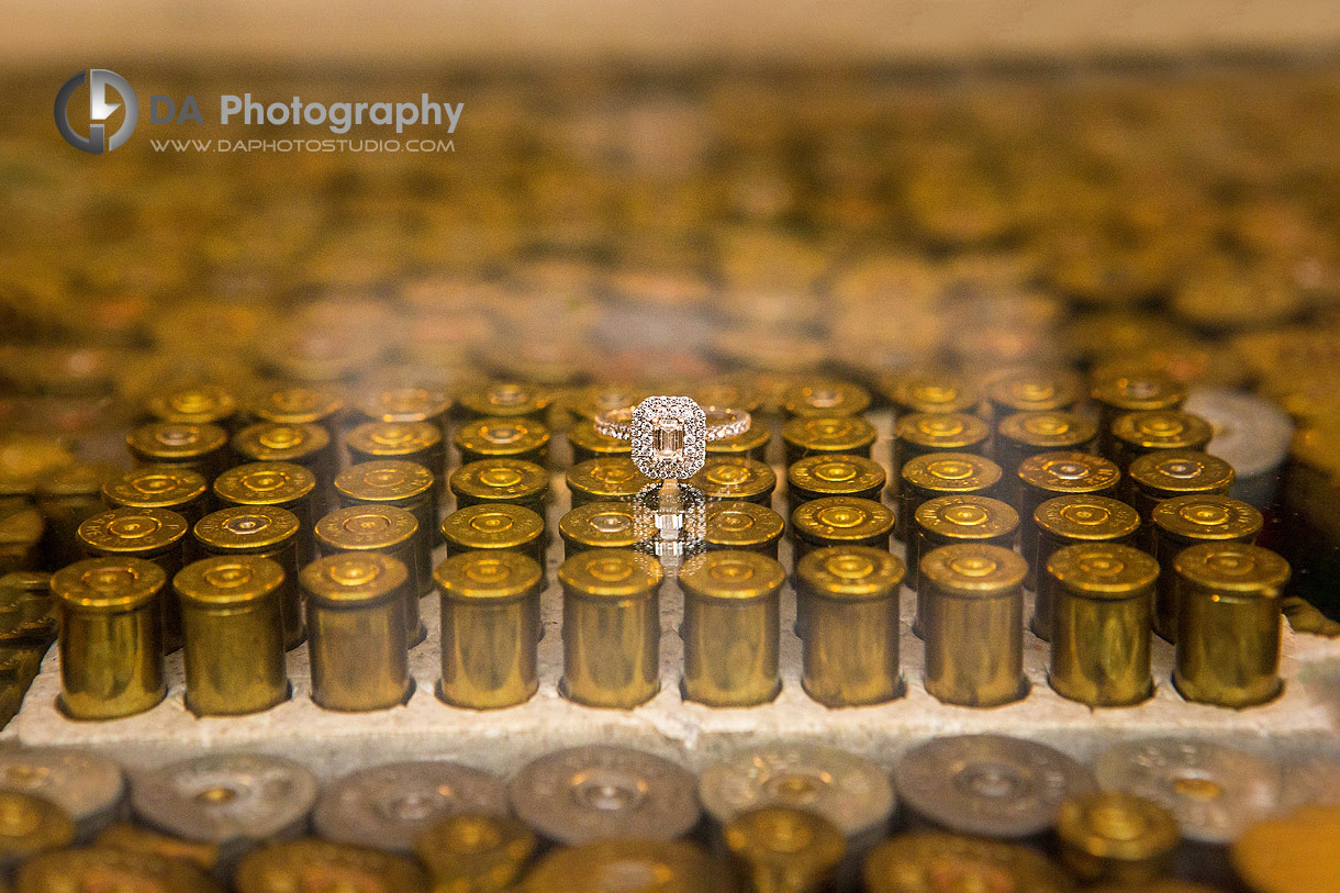 Creative photo of a wedding ring on a table made of a used bullet casings