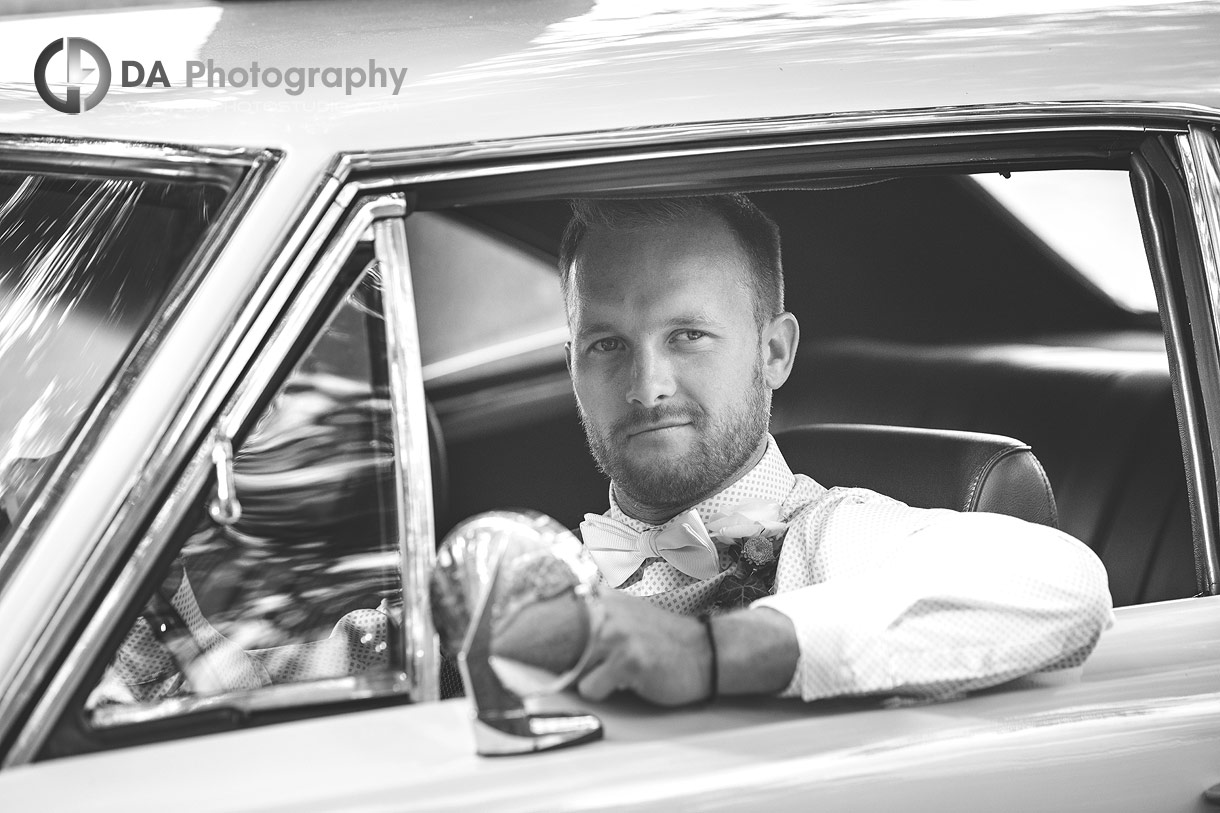 Photo of a Groom in his vintage car