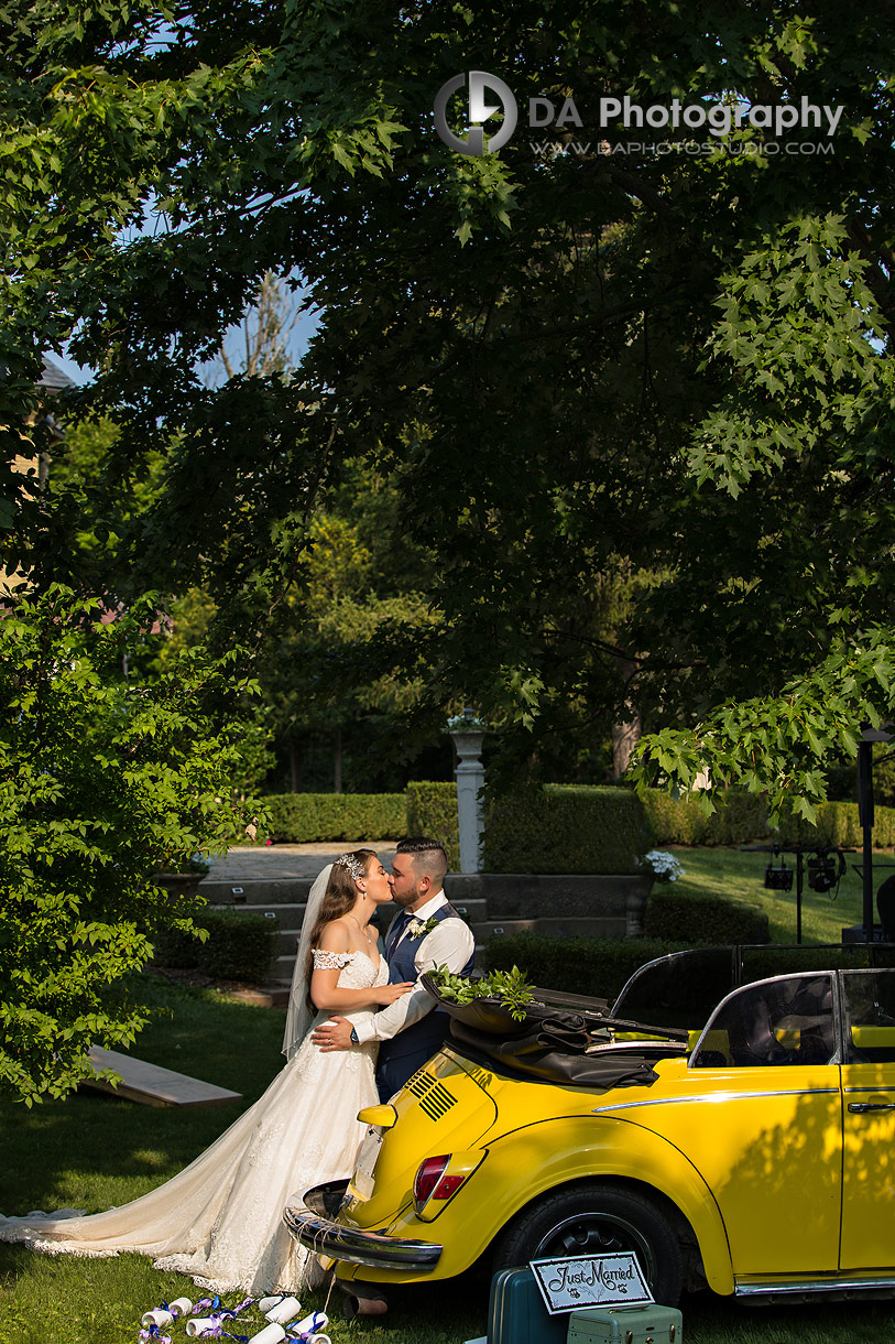 Bride and Groom by yellow Beetle car