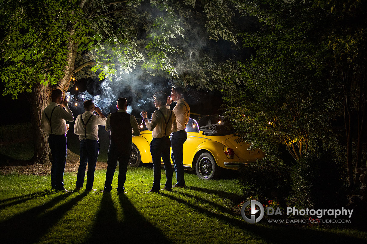 Groom with his groomsman's smoking cigars