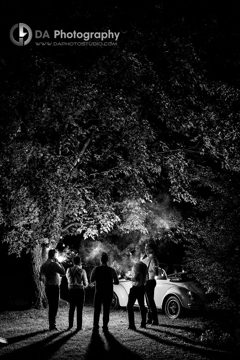 Photo of a Dramatic lights during Groom with his groomsman's smoking cigars