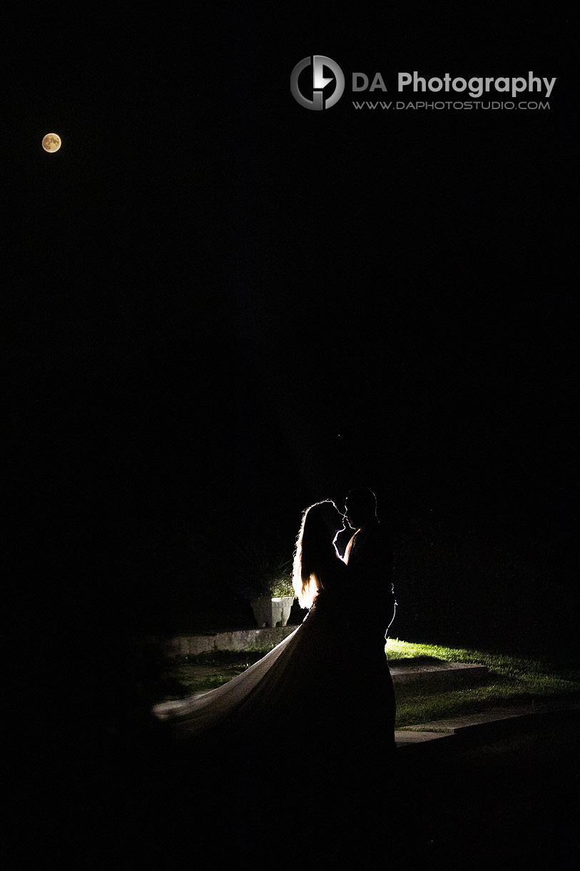 Bride and Groom night portrait with full moon in the back