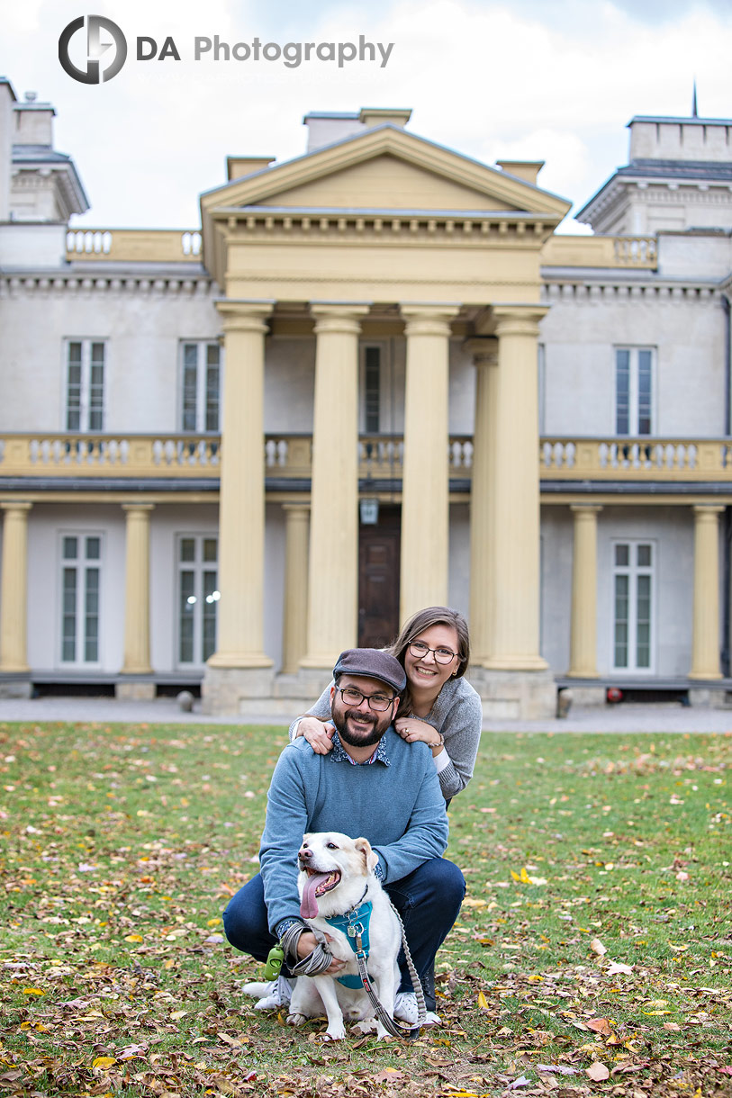 Engaged Couple posing with their dog in front of Dundurn Castle
