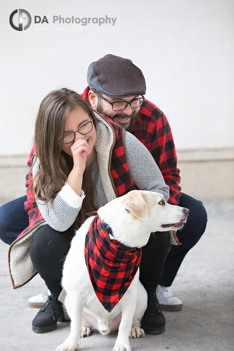 Fun interaction between couple and dog during fall engagement session