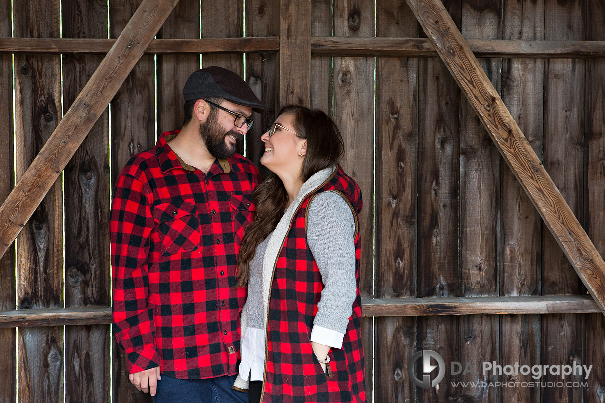 Engagement photos in Dundurn Castle coach house with textured wooden doors