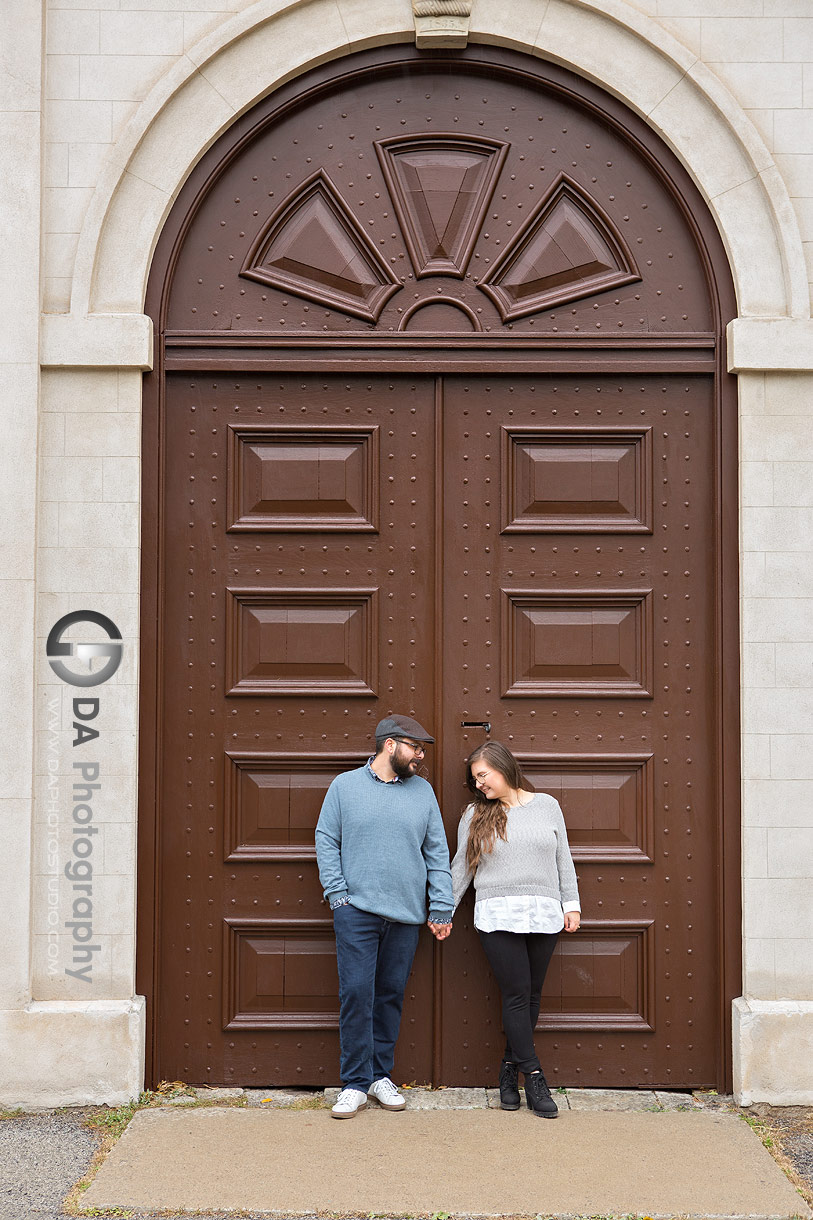 Couple standing near gate at Dundurn Castle during fall sunset