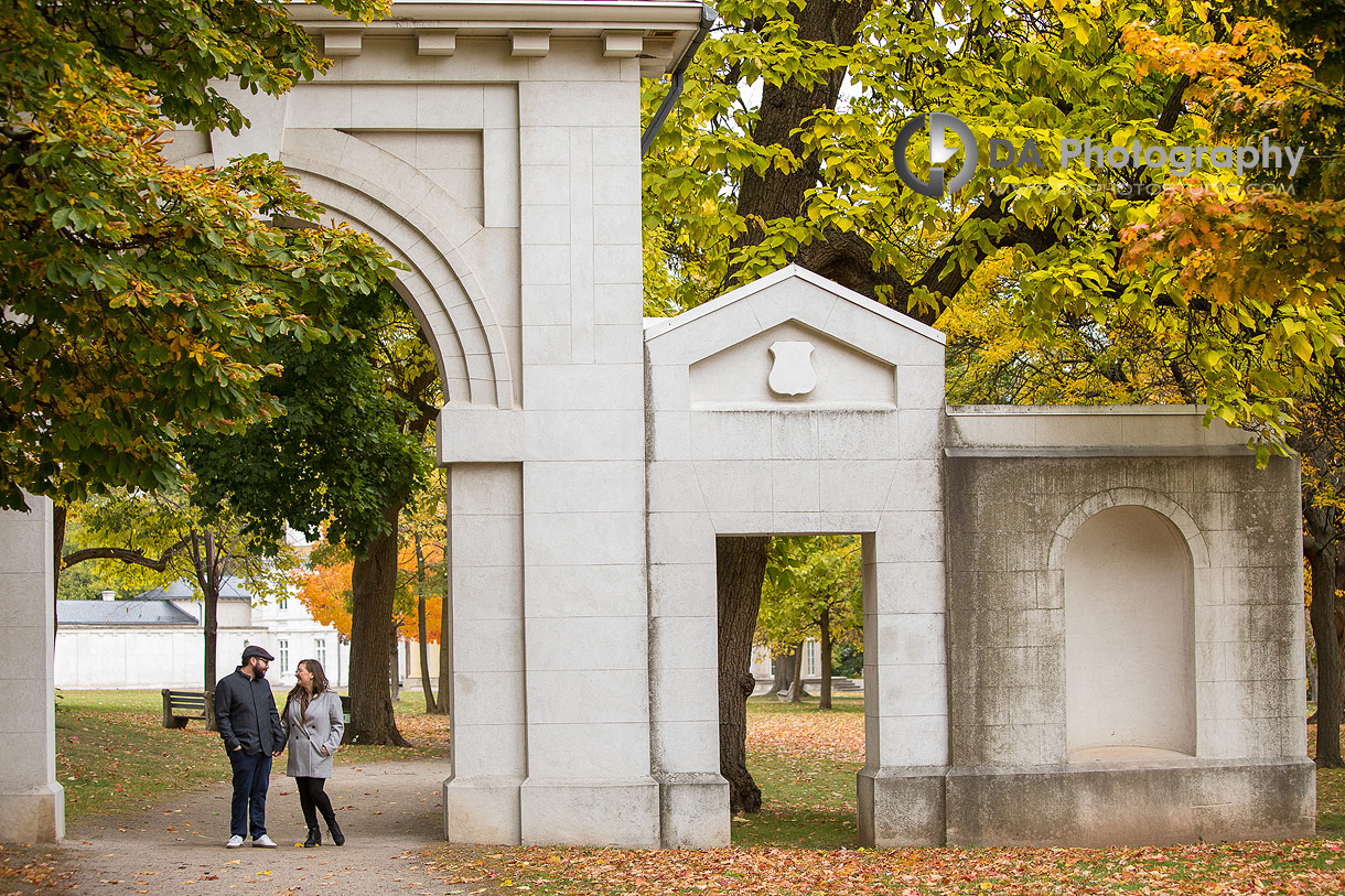 Candid engagement photo with colourful autumn trees near Dundurn Castle