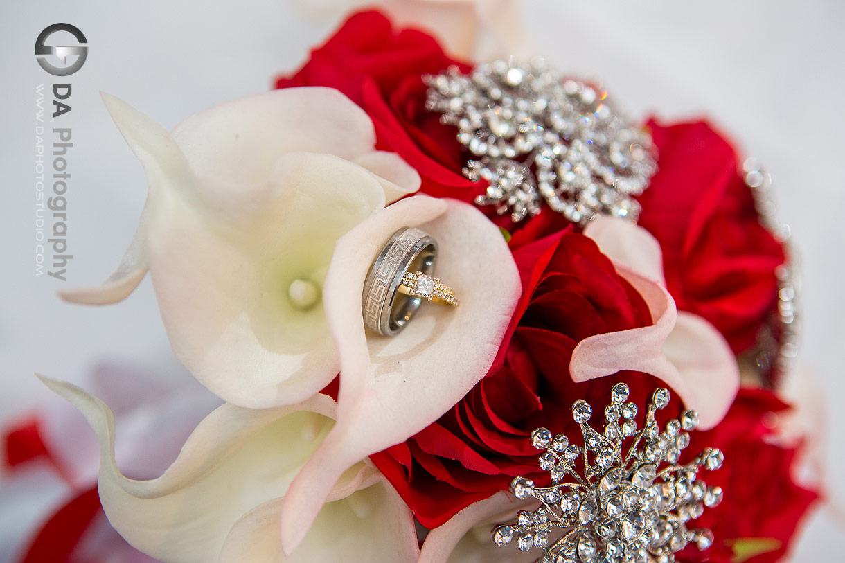 Close up photo of a wedding rings in a wedding bouquet