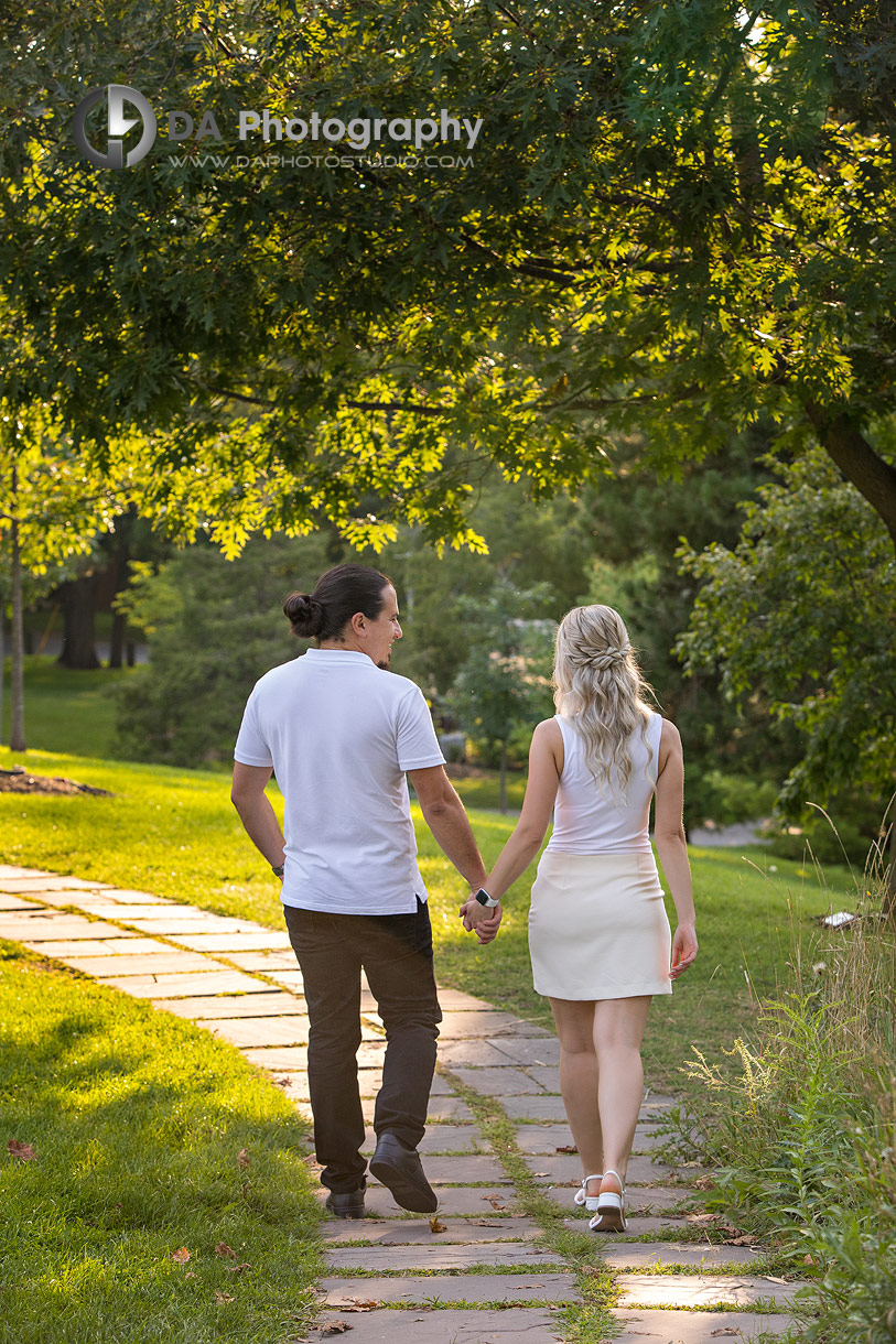 Sunset engagement portrait with warm, glowing light behind the couple