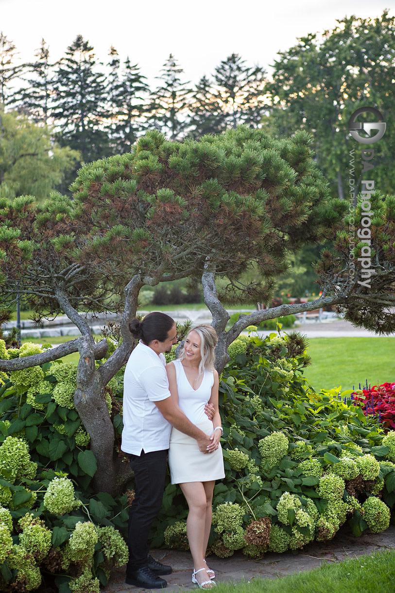 Engagement photo of the couple sharing a quiet moment near the waterfront at Gairloch Gardens