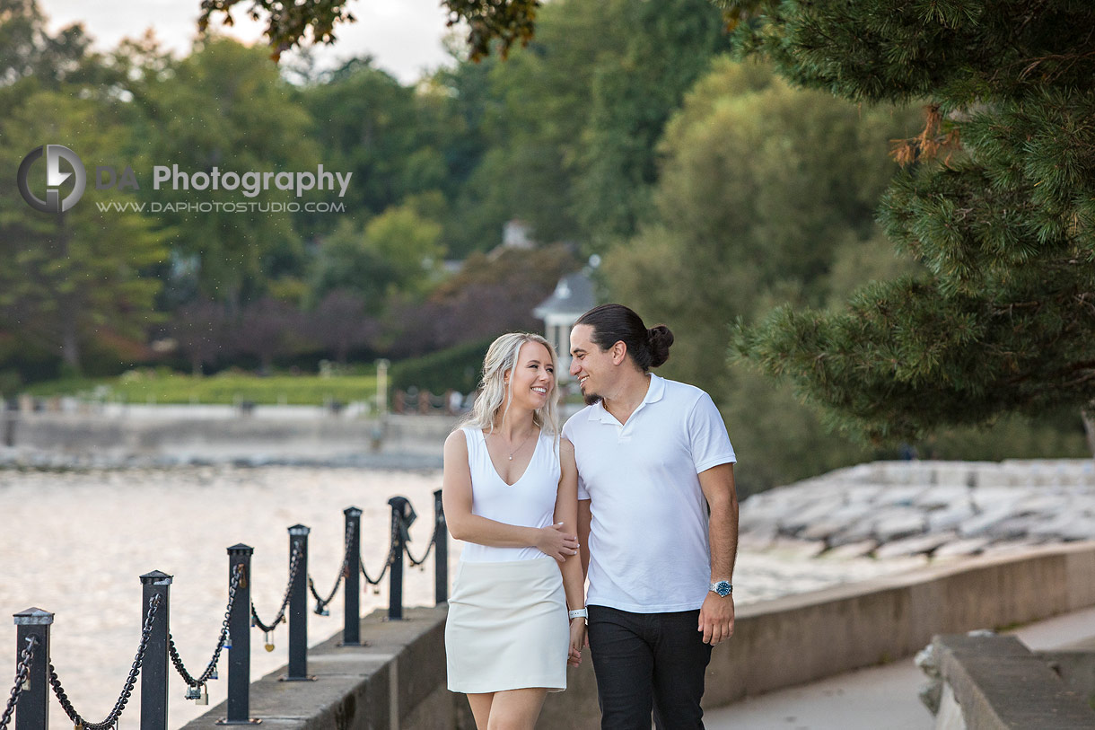 Couple framed by arching trees with soft sunset lighting in Gairloch Gardens