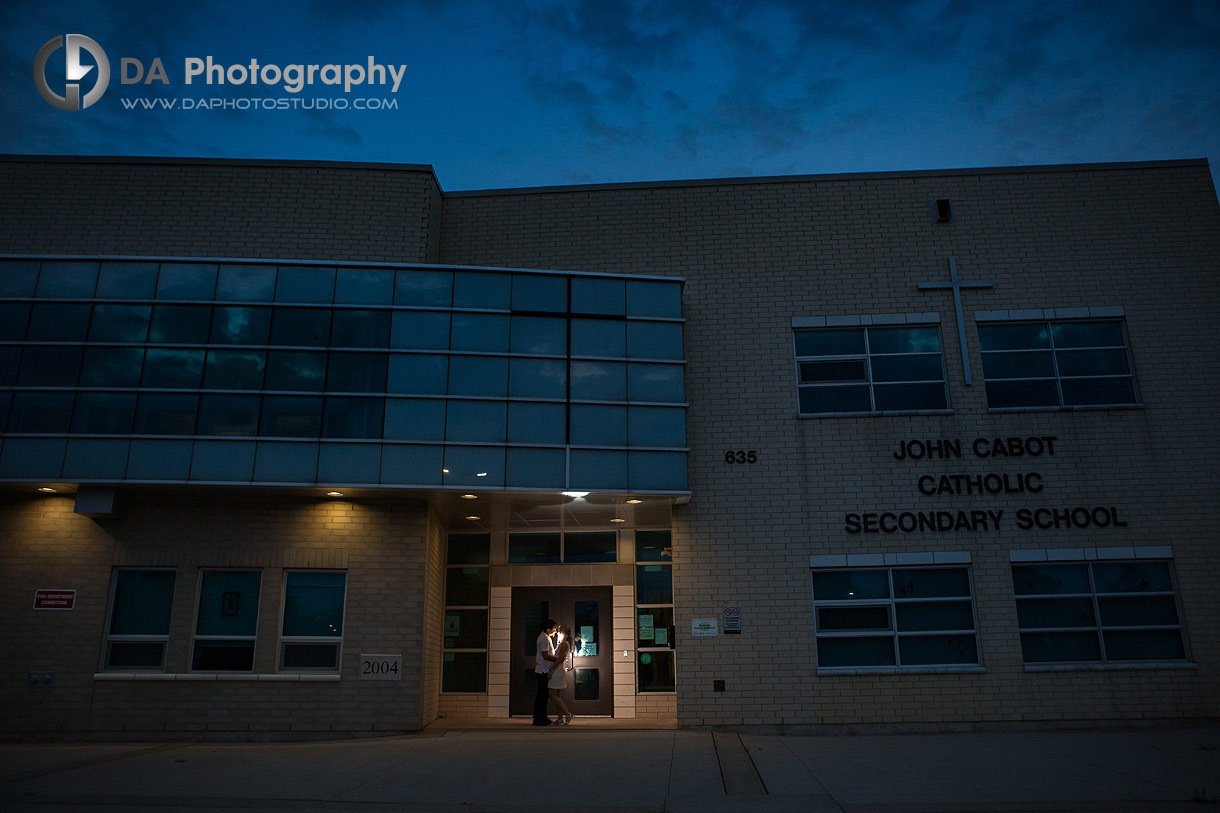 Silhouette of Cathy and Kevin holding each other near the school entrance