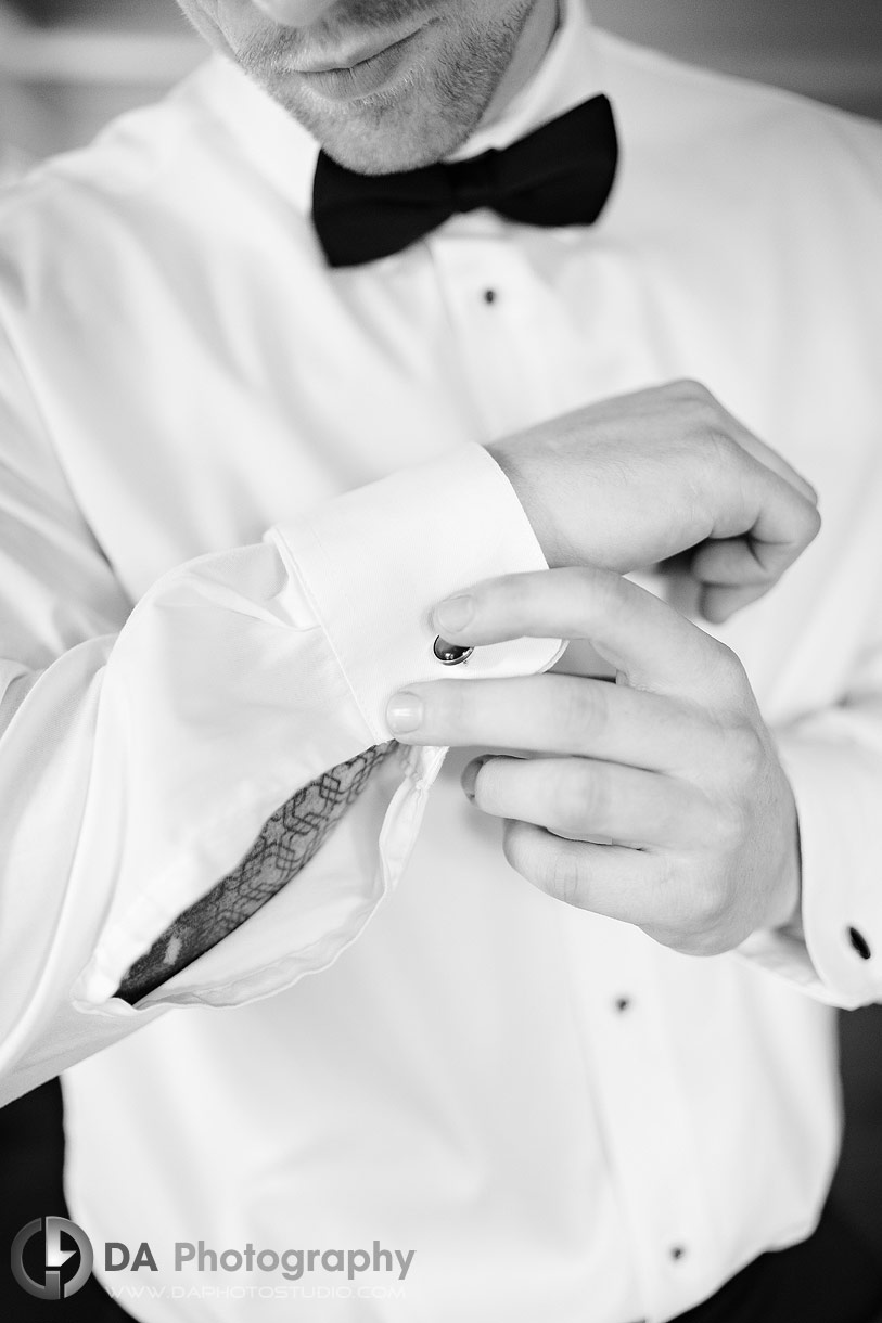 Photo of Groom fixing his cufflinks