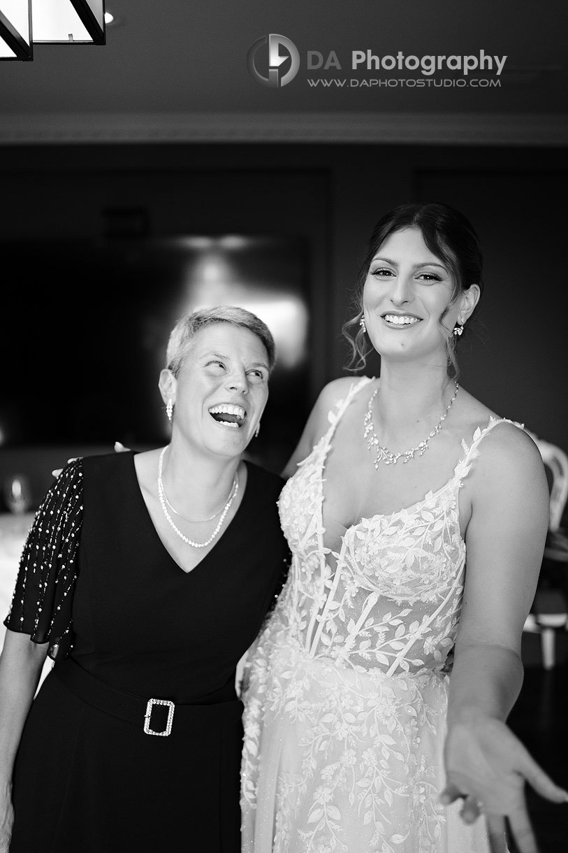Candid photo of bride with her mom smiling