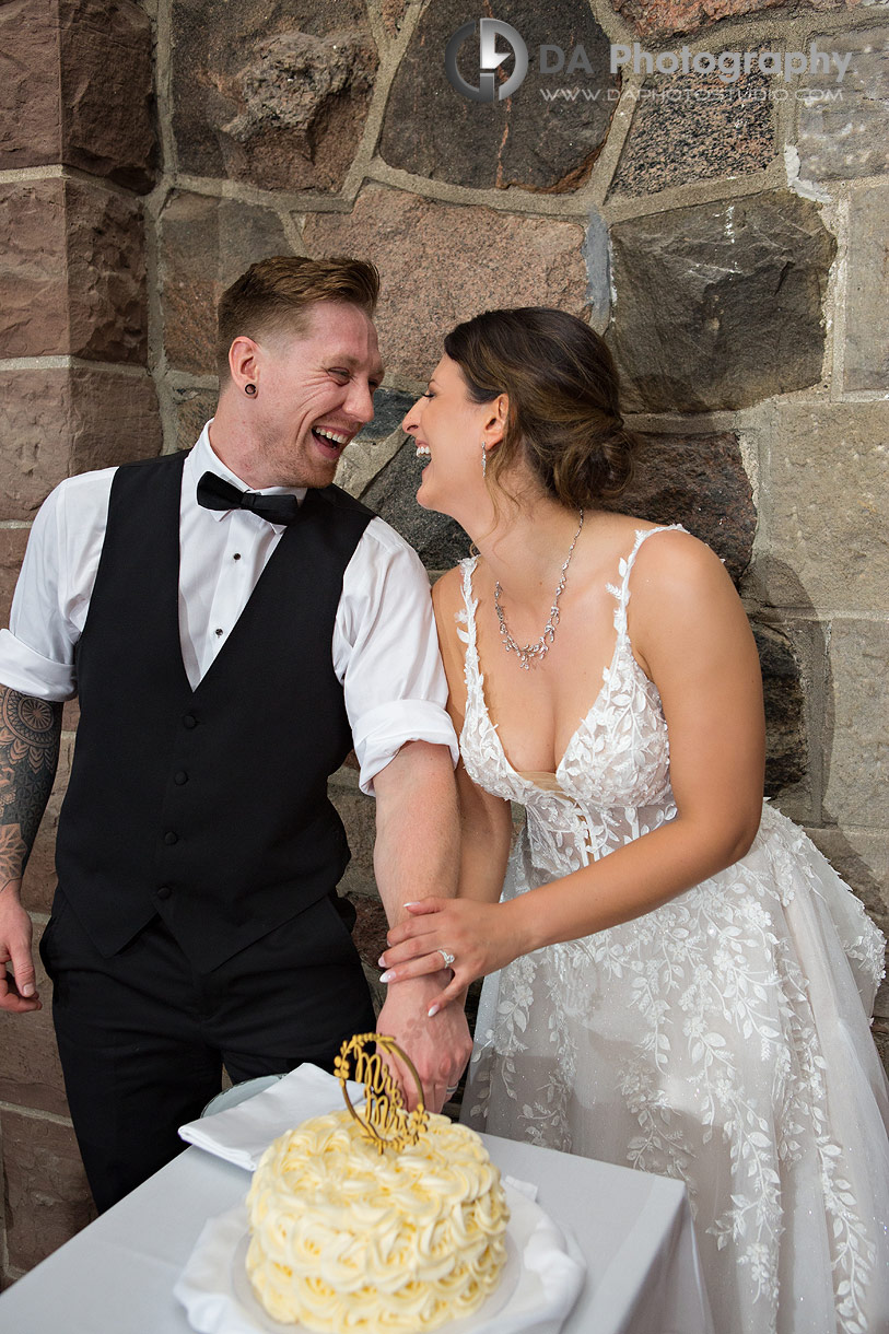 Fun photo of a bride and groom cutting wedding cake