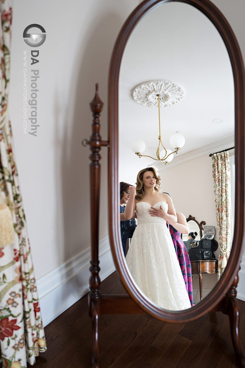Bride looking in a mirror during getting ready photos