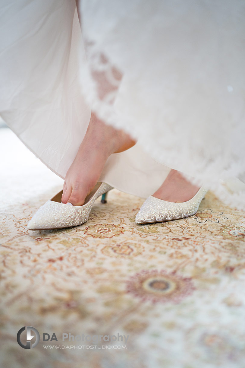 Bride getting into her wedding shoes