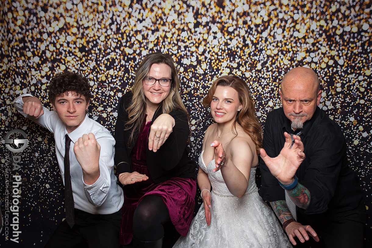 Bride getting photo taken with her guests on a photo booth