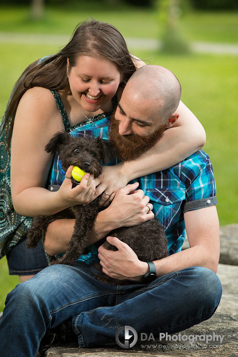 Photo of a couple playing with their puppy